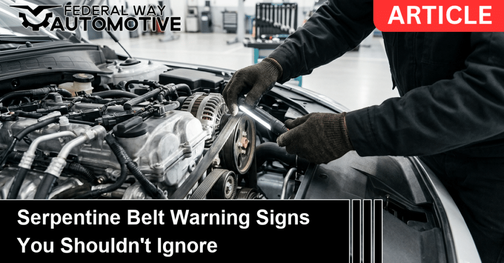 Technician inspecting a worn serpentine belt and pulleys on a car engine in a clean shop