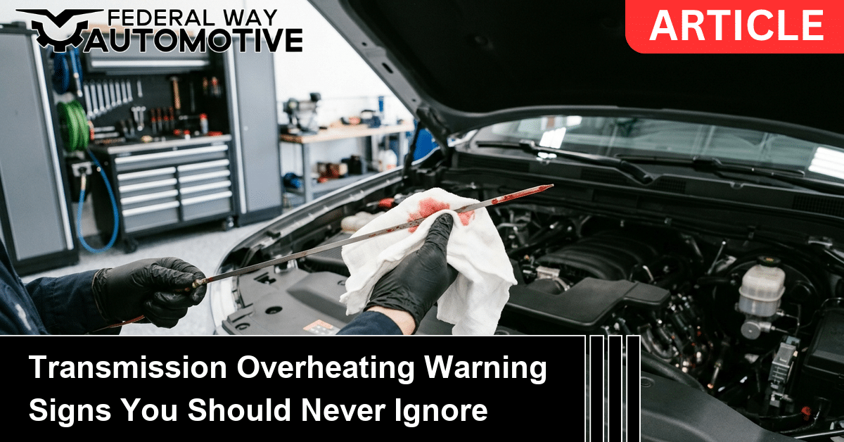 Technician checking transmission fluid for transmission overheating warning signs